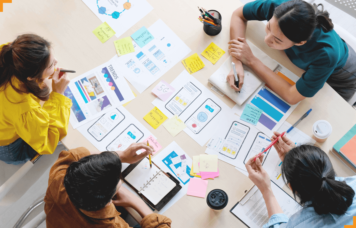 Banner featuring a teacher with children learning at a table, highlighting Mitr’s Creative and UI/UX services, including UI/UX design, animation, immersive experiences, and interactive learning solutions.